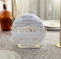 Additional picture of Round Lucite Bencher Holder Laser Cut Flower Design with 8 White Lucite Hebrew Birchas Hamazon Cards Ashkenaz Pearl Gold 7.8"