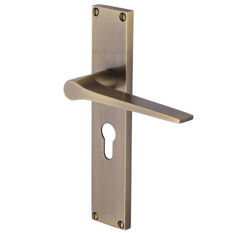 Heritage Gio Euro Lock Door Handles Antique Brass Lacquered Broughtons Lighting And Ironmongery