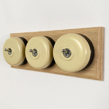 Round Dolly Light Switch 3 Gang Stone on Oak Pattress with Black Mount
