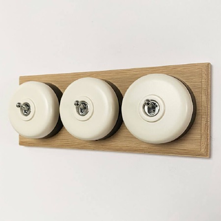 Round Dolly Light Switch 3 Gang White on Oak Pattress with Black Mount