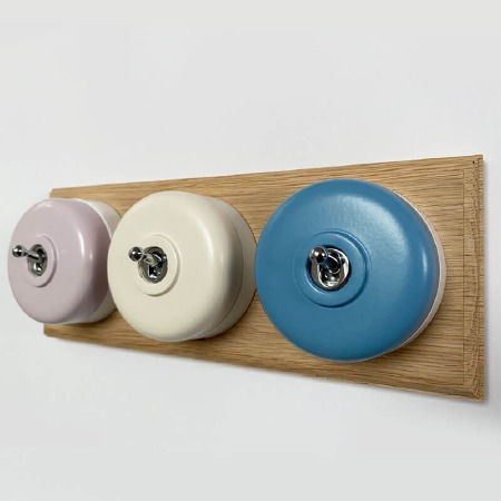 Round Dolly Light Switch 3 Gang Mix and Match on Oak Pattress with White Mounts
