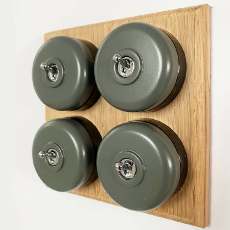 Round Dolly Light Switch 4 Gang Light Grey on Oak Pattress with Black Mounts