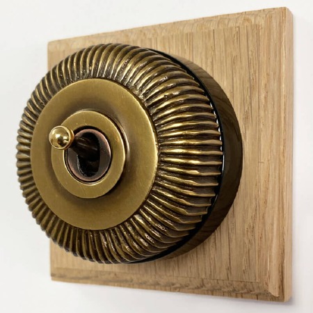 Reeded Round Dolly Light Switch 1 Gang Antique Satin Brass Black Base