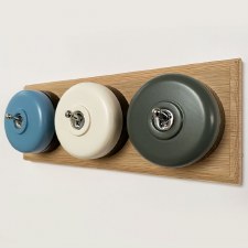 Round Dolly Light Switch 3 Gang Mix and Match on Oak Pattress with Black Mounts