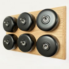 Round Dolly Light Switch 6 Gang Black on Oak Pattress with Black Mounts