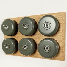 Round Dolly Light Switch 6 Gang Light Grey on Oak Pattress with Black Mounts