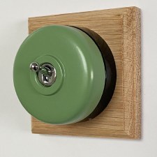 Round Dolly Light Switch Green on Square Oak Pattress with Black Mount