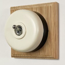 Round Dolly Light Switch White on Square Oak Pattress with Black Mount