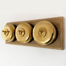 Round Dolly Light Switch 3 Gang on Oak Base Polished Brass Black