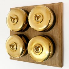 Round Dolly Light Switch 4 Gang on Oak Base Polished Brass Black