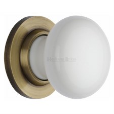 Heritage Porcelain Door Knobs White with Antique Brass Rose