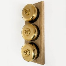 Additional picture of Round Dolly Light Switch 3 Gang on Oak Base Polished Brass Black