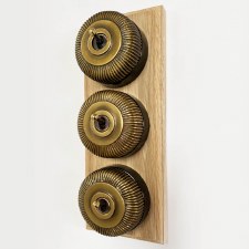 Additional picture of Reeded Round Dolly Light Switch 3 Gang on Oak Base Antique Satin Brass Black