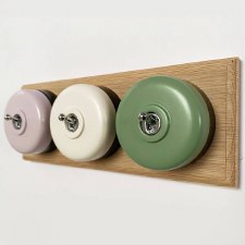 Additional picture of Round Dolly Light Switch 3 Gang Mix and Match on Oak Pattress with Black Mounts