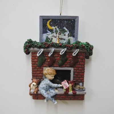 BOY  INFRONT OF FIREPLACE