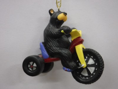 BLACK BEAR RIDING A BIG WHEEL