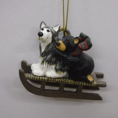 BLACK BEAR RIDING A SLED