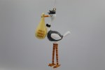 STORK CARRYING YELLOW BUNDLE