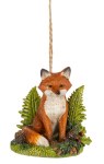 FOX SITTING UPRIGHT IN FERNS