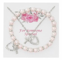 CRYSTAL AND PINK PEARL STRETCH BRACELET WITH CRYSTAL CROSS AND HEART PENDANT ON 16-18'' CHAIN