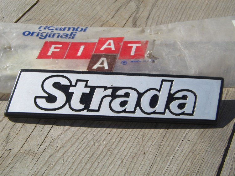 "STRADA" EMBLEM, LEFT FENDER