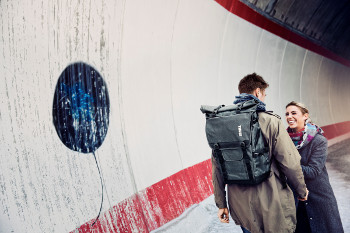 Thule Covert DSLR Rolltop Camera Backpack lifestyle product shot 1