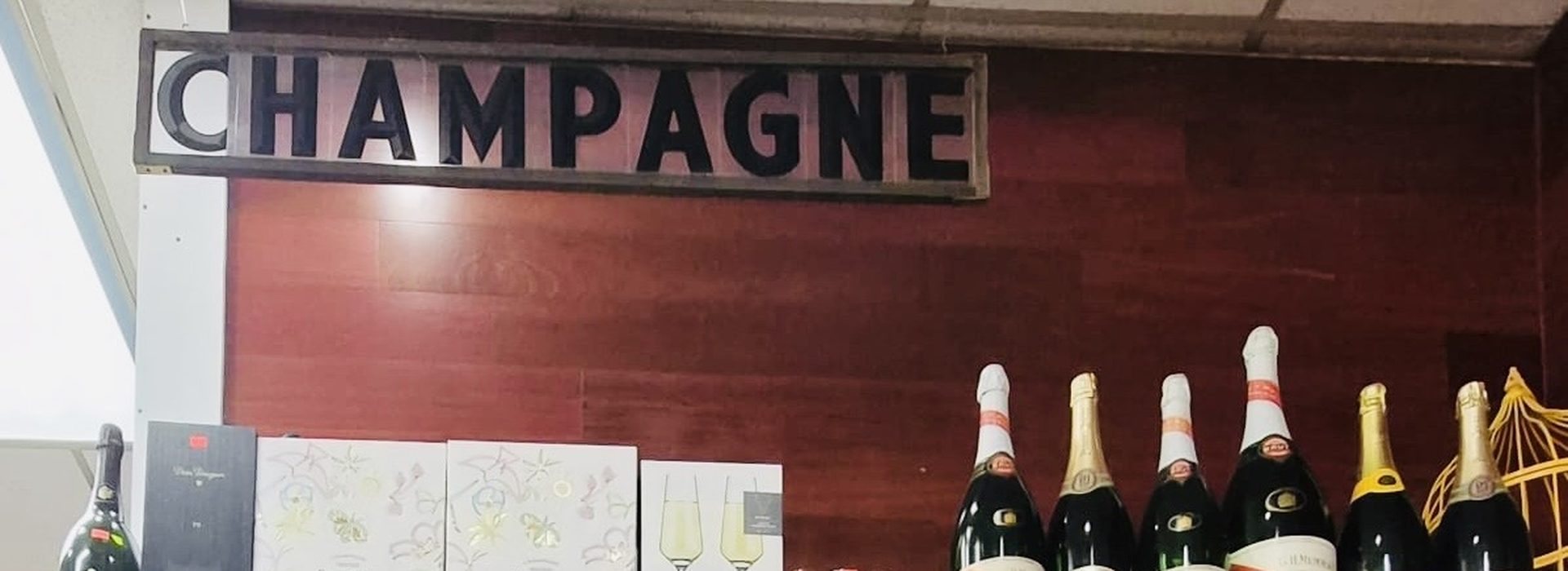 Champagne display against red wood wall at Chevy Chase Wine & Spirits