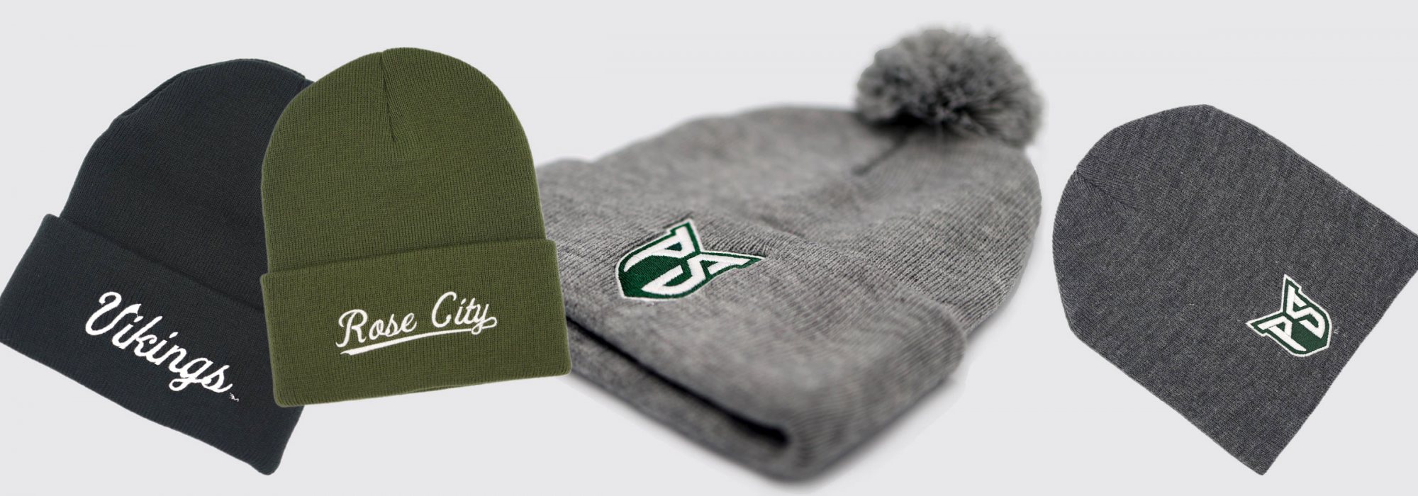 A selection of stocking caps with P S U shields or that say Vikings or Rose City. 